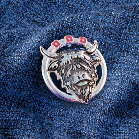 Woman with poppy brooch from the Poppyscotland jewellery Collection pinned to her scarf