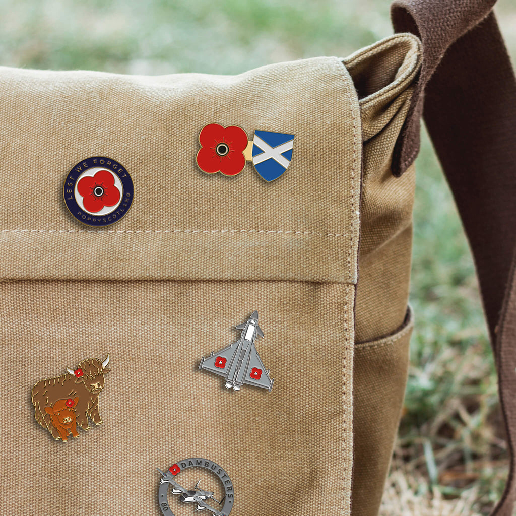 Some of our new Poppyscotland poppy pin badges pinned onto a canvas bag.