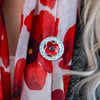 Celtic Crest Poppy Brooch worn on poppy scarf | Poppyscotland