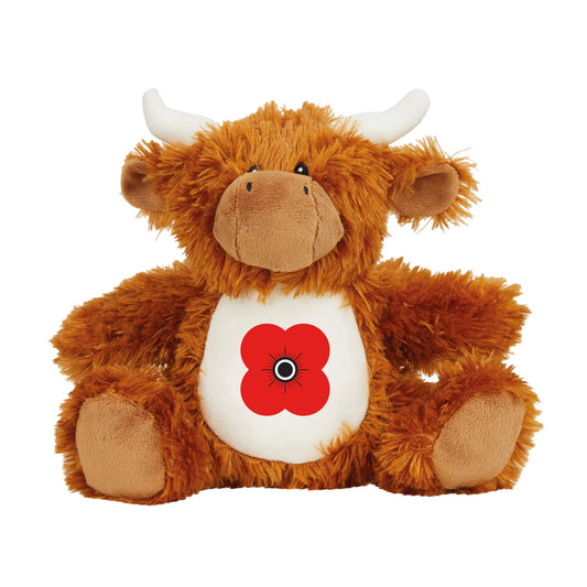 A plush toy resembling a Highland cow with a white belly featuring a red poppy emblem.